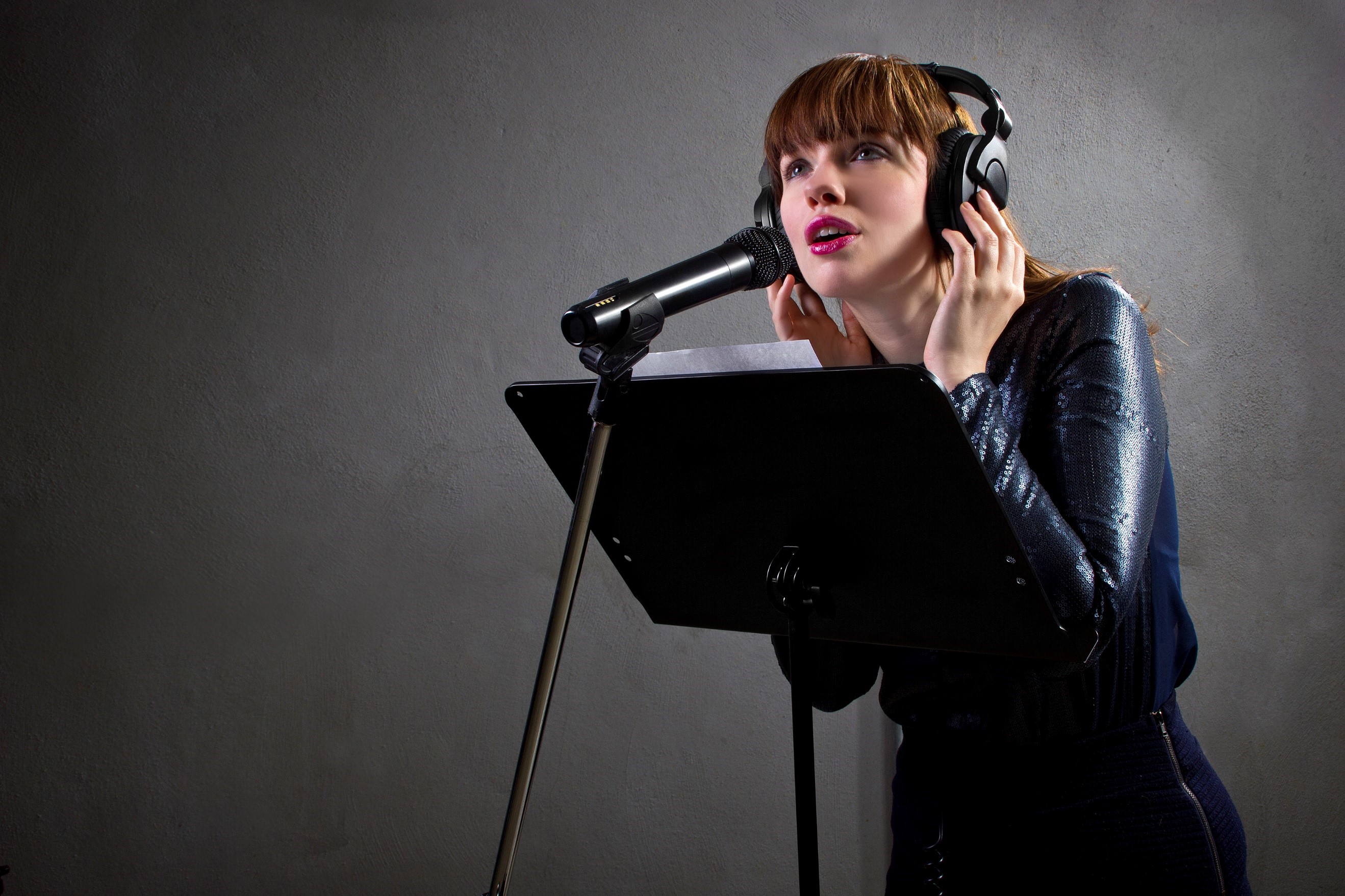 professional female voiceover artist with headphones and microphone